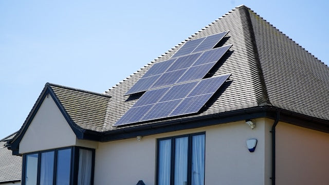 Residential home with 14 solar panels on the roof.